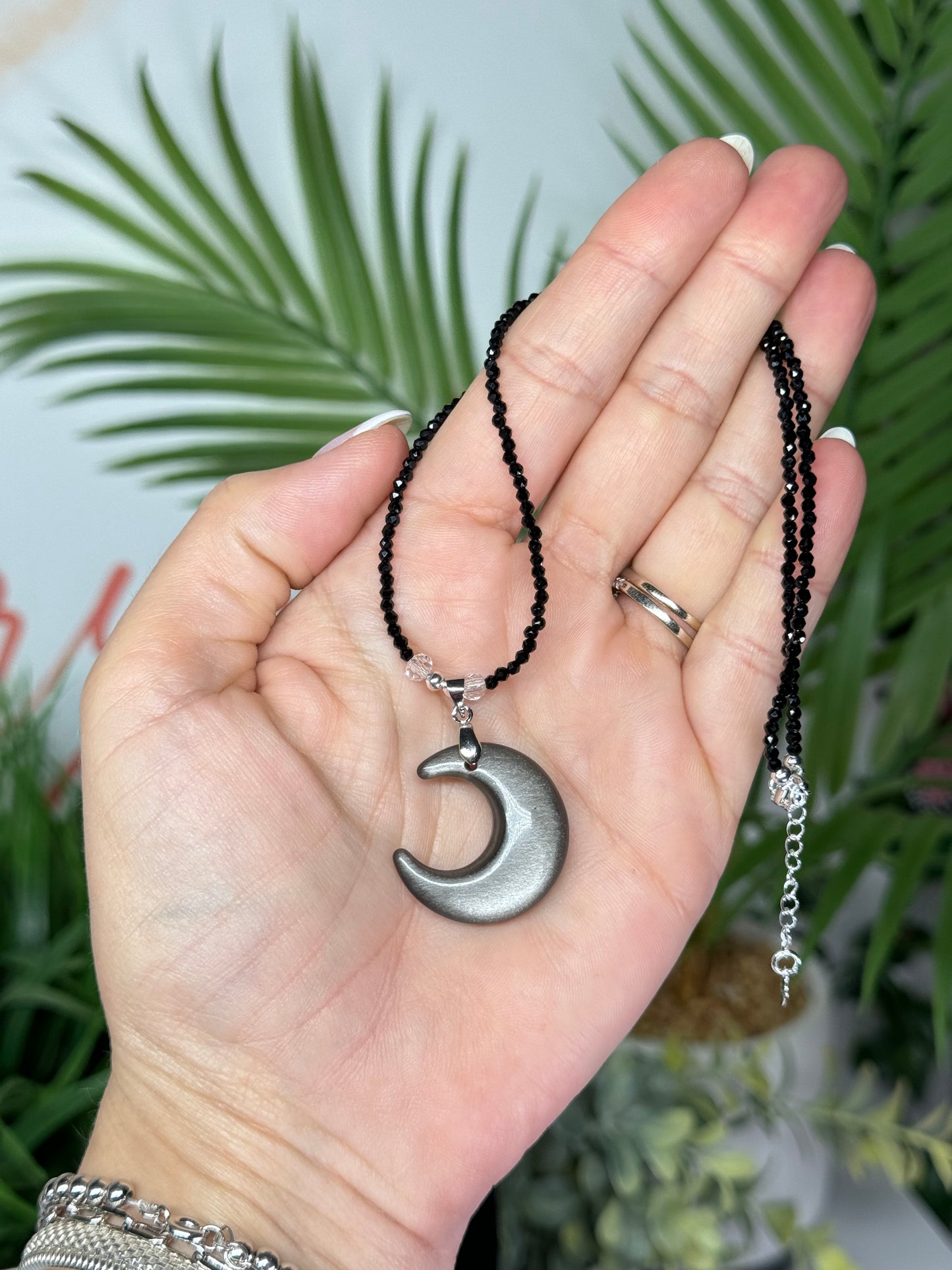 Silver sheen obsidian moon necklace. Silver plated hardware and adjustable 15.5-17” long.