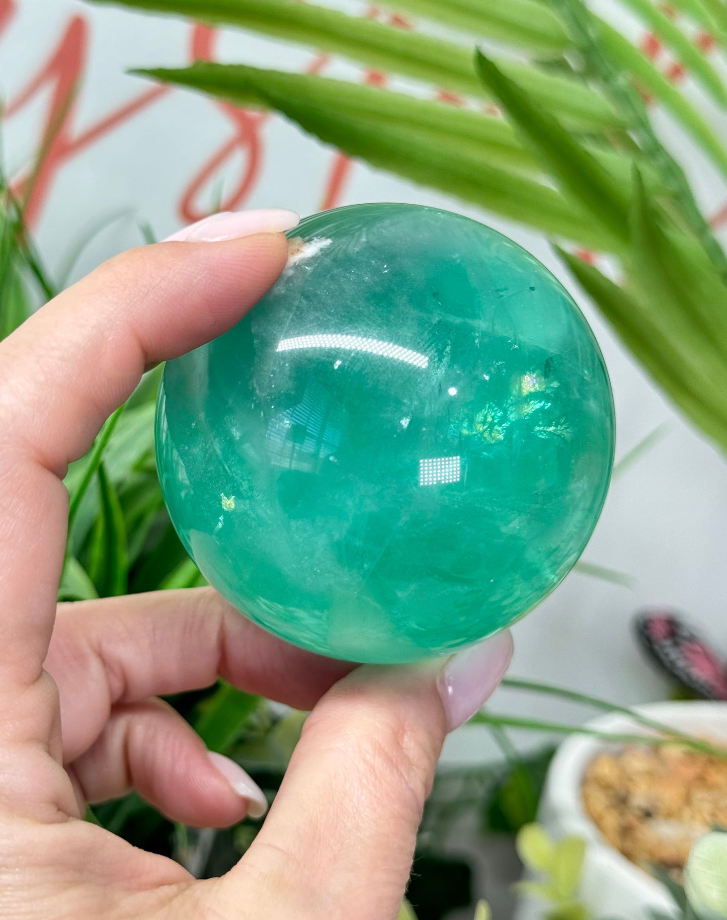 Mint green fluorite sphere. 60mm and will include a sphere stand. *see attached photos for back lighting