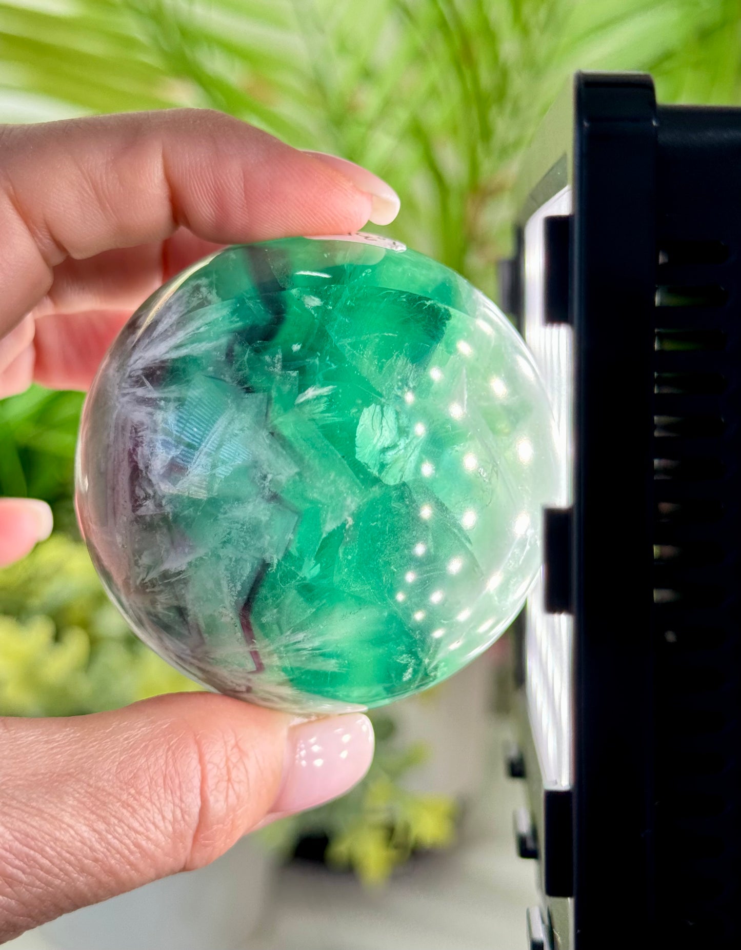 Large feather fluorite sphere. 60mm and will include a sphere stand. *see attached photos for back lighting