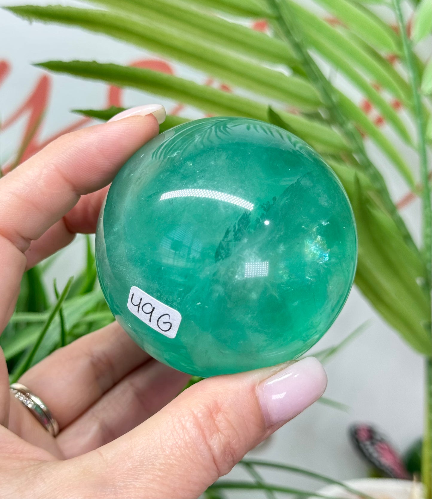 Mint green fluorite sphere. 60mm and will include a sphere stand. *see attached photos for back lighting