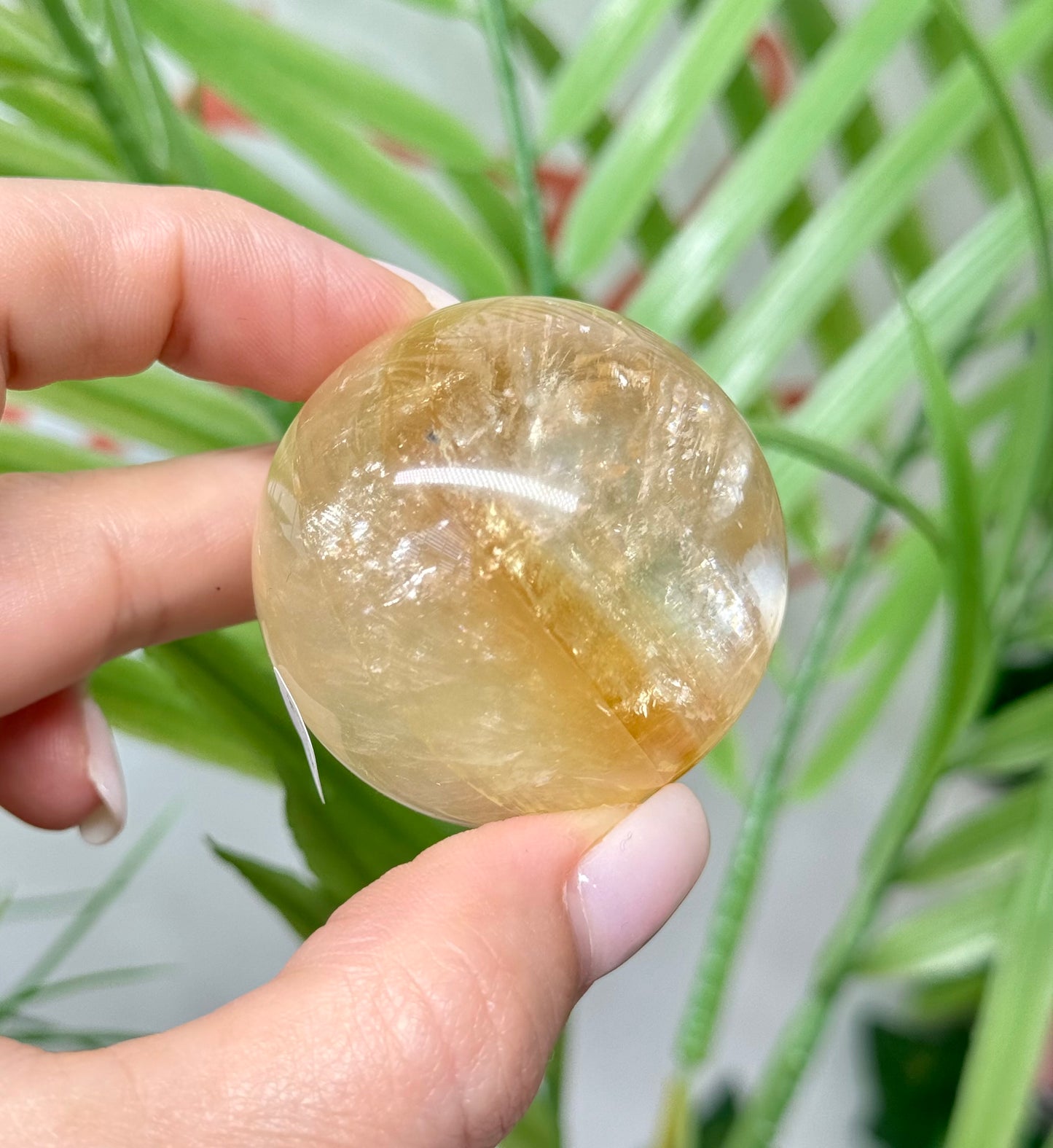 Honey calcite sphere. 42mm includes a sphere stand