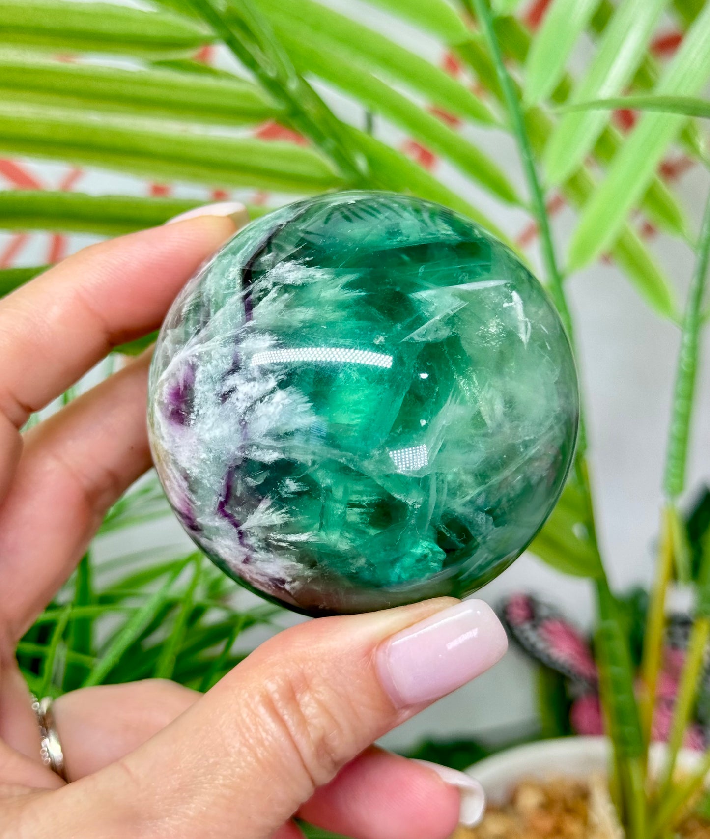 Large feather fluorite sphere. 60mm and will include a sphere stand. *see attached photos for back lighting