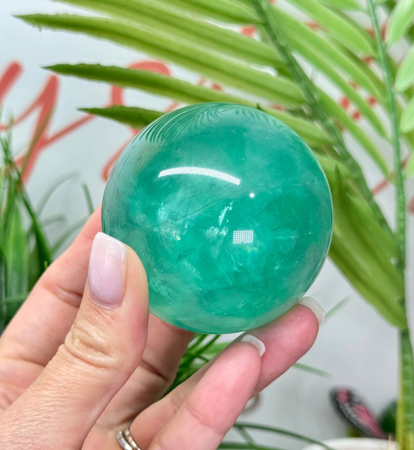 Mint green fluorite sphere. 60mm and will include a sphere stand. *see attached photos for back lighting