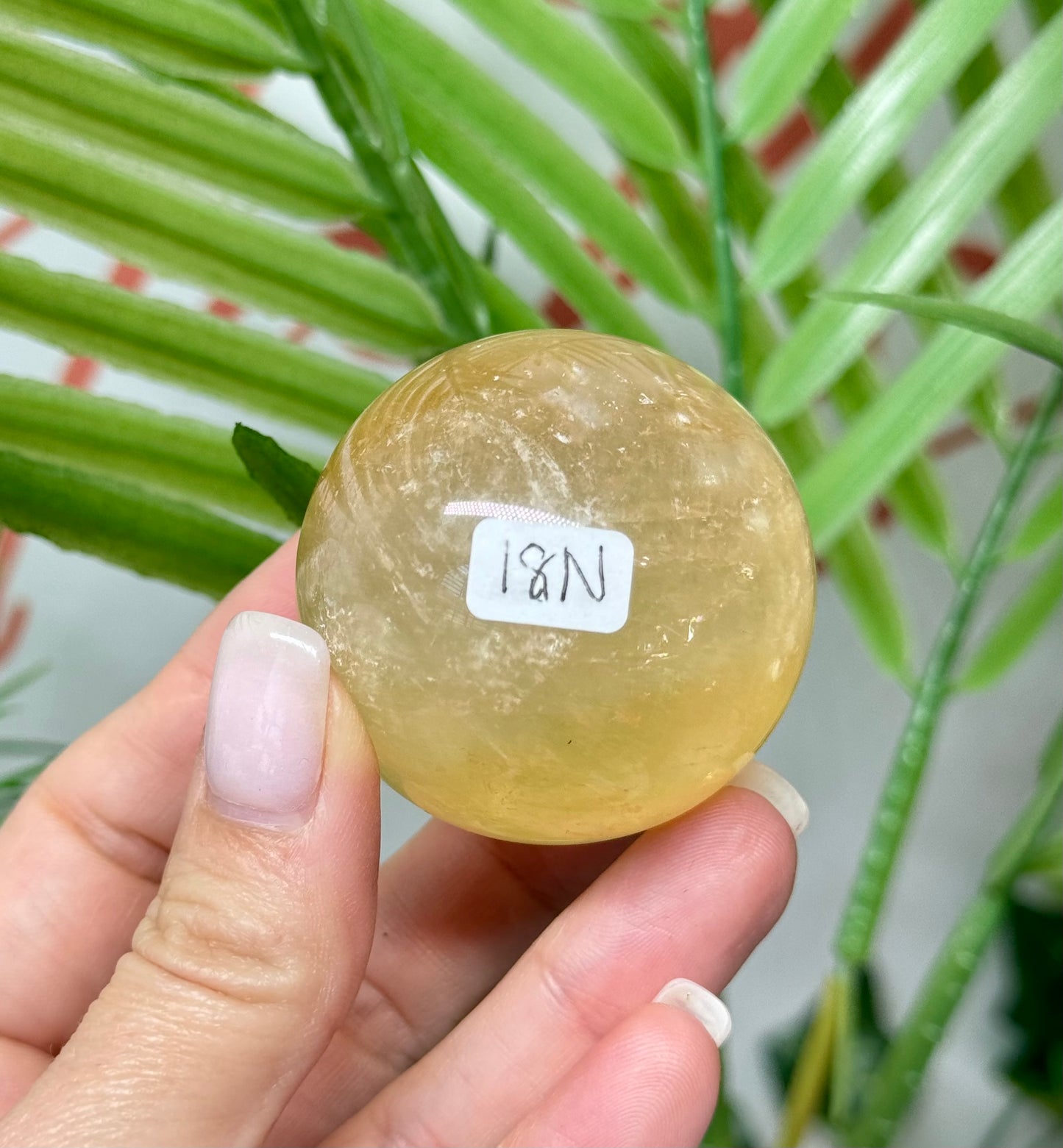 Honey calcite sphere. 44.5mm includes a spheres stand