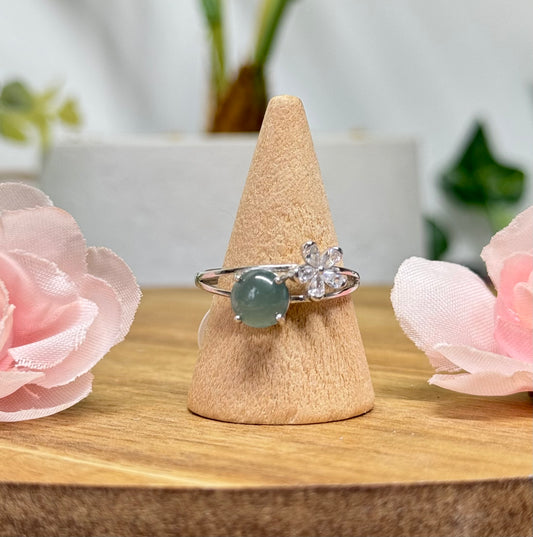 Blue water jade ring with CZ flower accent. S925 sterling silver and adjustable to fit size 5-10