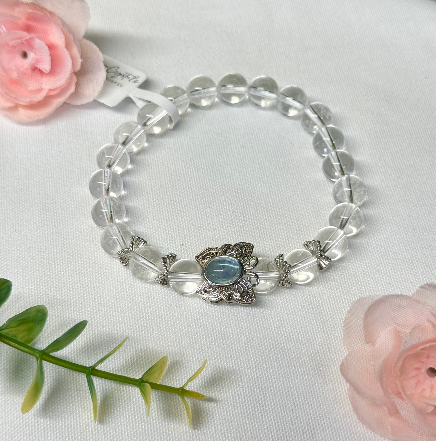 Clear Quartz bracelet with aquamarine butterfly bead. 8mm beads. Size 7” and can be resized