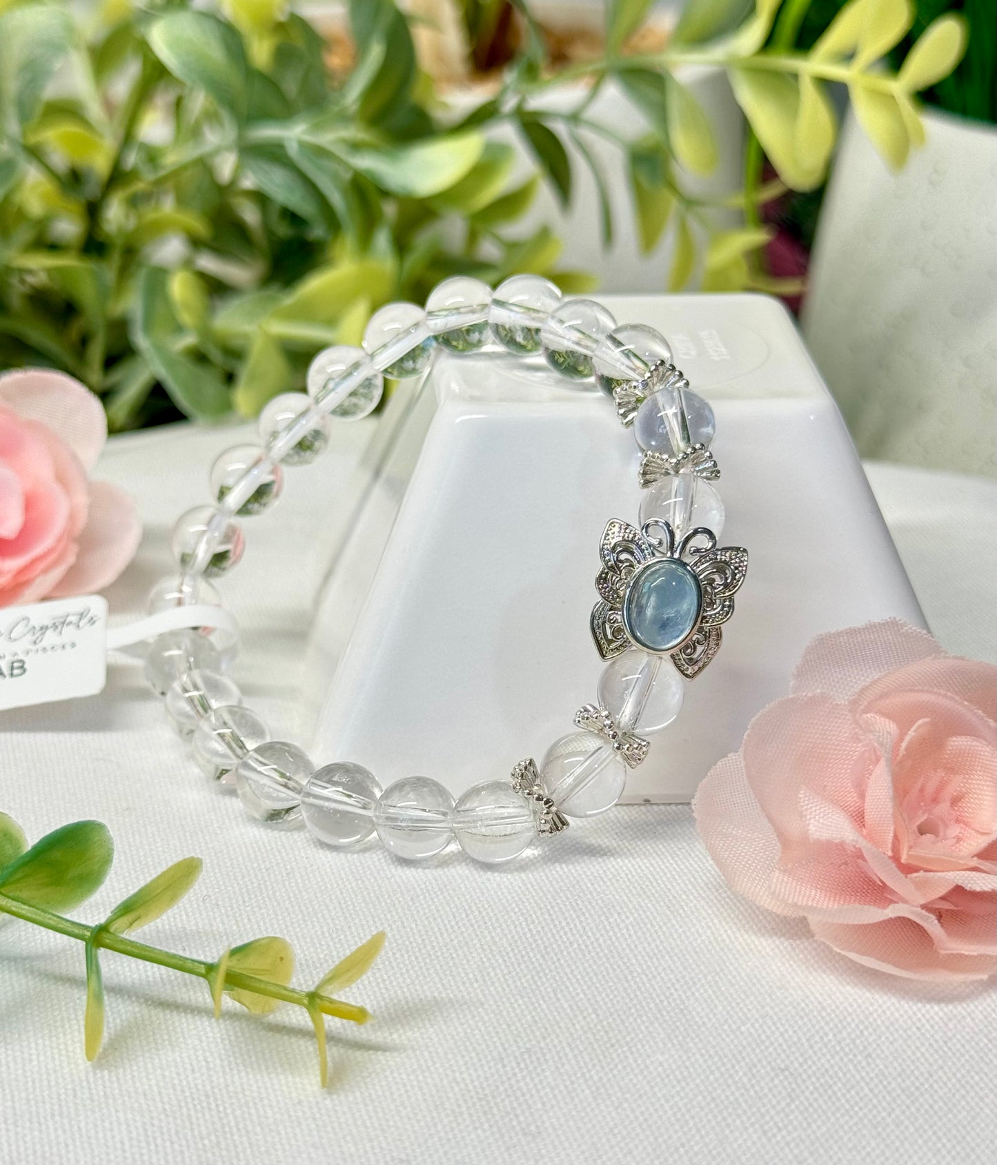 Clear Quartz bracelet with aquamarine butterfly bead. 8mm beads. Size 7” and can be resized